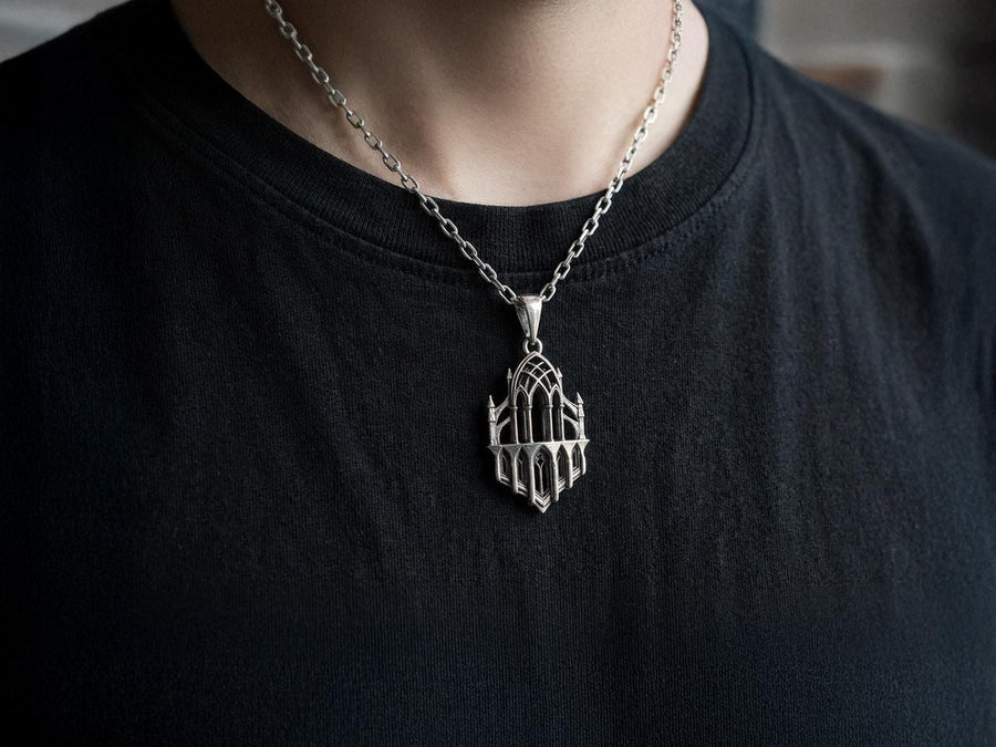 This macro image highlights the masterful craftsmanship of the solid 925 sterling silver casting. The artisan has flawlessly translated monumental stone architecture into miniature metalwork. The columns are smooth and precise, while deep sulfur oxidation creates a permanent matte black shadow in the open recesses of the arches. This traditional antiquing technique gives the gothic relic pendant the weathered, enduring texture of an actual historical cathedral fragment. (etsy image id: 7979026828)