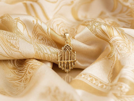 Reimagined in solid 14k yellow gold, this gothic relic pendant transforms from a brooding stone sanctuary into a radiant, museum-quality reliquary. The warm gold illuminates the intricate lancet arches and slender columns, giving the architectural relief an opulent, regal glow reminiscent of precious medieval church treasures. The dark oxidation is replaced by a soft, brushed matte finish in the recesses, elevating this historical motif into a luxurious fine jewelry masterpiece. (etsy image id: 8026976789)