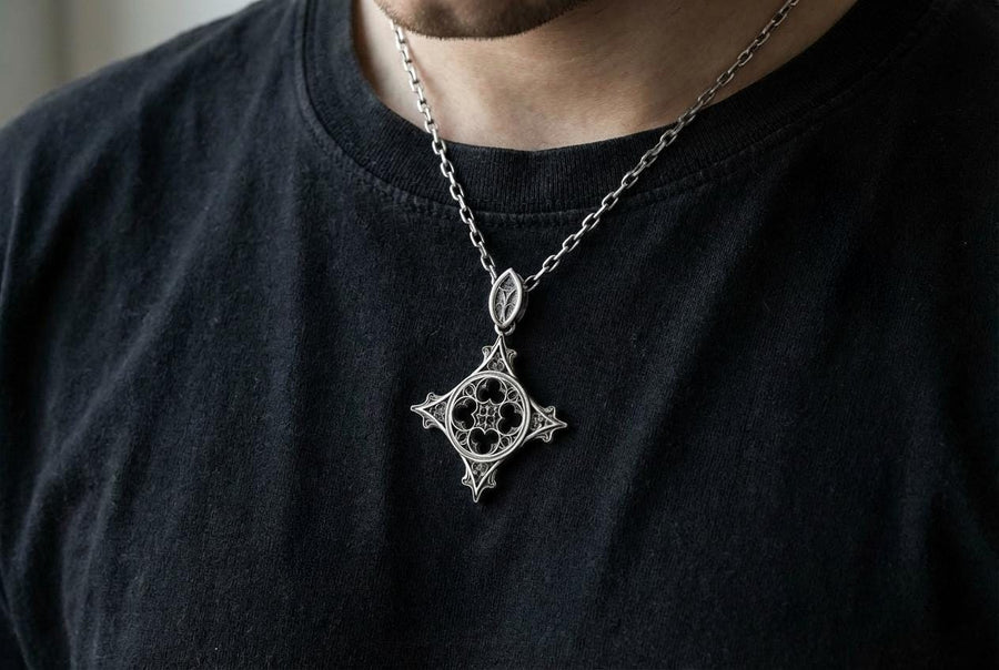 Showcasing exceptional openwork silversmithing, this gothic cross pendant demonstrates precise micro-casting techniques. The slender mullions and tracery lines are perfectly symmetrical and structurally sound, maintaining the airy lightness of a true cathedral window. A sturdy, intricately decorated silver bail is seamlessly integrated into the top point, ensuring the heavy charm hangs perfectly balanced on its chain. (etsy image id: 8027043505)