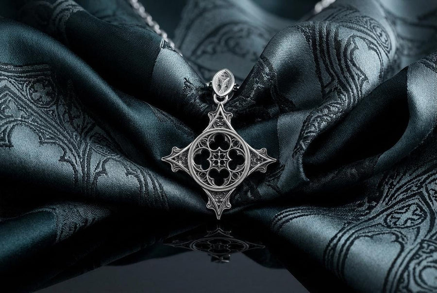 Showcasing exceptional openwork silversmithing, this gothic cross pendant demonstrates precise micro-casting techniques. The slender mullions and tracery lines are perfectly symmetrical and structurally sound, maintaining the airy lightness of a true cathedral window. A sturdy, intricately decorated silver bail is seamlessly integrated into the top point, ensuring the heavy charm hangs perfectly balanced on its chain. (etsy image id: 8027043505)