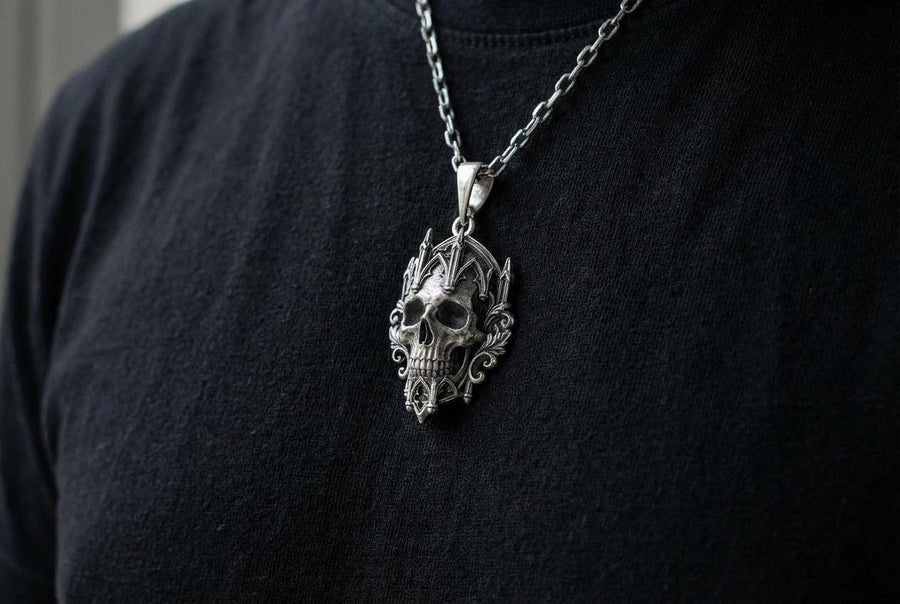 This macro image highlights the masterful texturing of the solid 925 sterling silver casting. The artisan has beautifully captured the smooth, anatomical curves of the organic skull, contrasting them against the rigid, geometric lines of the gothic tracery and cathedral spires. A deep sulfur patina treatment provides permanent matte black shadows, giving this wearable sculpture the rugged, weathered patina of a genuine historical artifact. (etsy image id: 7979410208)