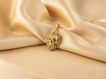 Reimagined in solid 14k yellow gold, this gothic cathedral skull pendant transforms from a brooding silver artifact into a radiant, museum-quality reliquary. The warm gold illuminates the intricate lancet arches and the organic skull, giving the macabre design an opulent, regal glow reminiscent of precious imperial treasures and saintly relics. A soft, brushed matte finish in the recesses elevates this wearable sculpture into a luxurious masterpiece. (etsy image id: 8027359061)