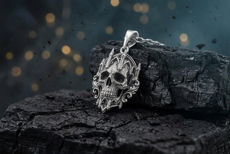 A close-up studio photograph of a highly detailed sterling silver pendant hanging vertically against a pitch-black background. The striking design features a realistic, organic human skull nestled within an ornate Gothic architectural frame. The frame mimics a cathedral window, complete with pointed lancet arches, intricate stone tracery, and soaring spires. The polished silver highlights contrast with dark oxidation in the eye sockets. (etsy image id: 8027369563)