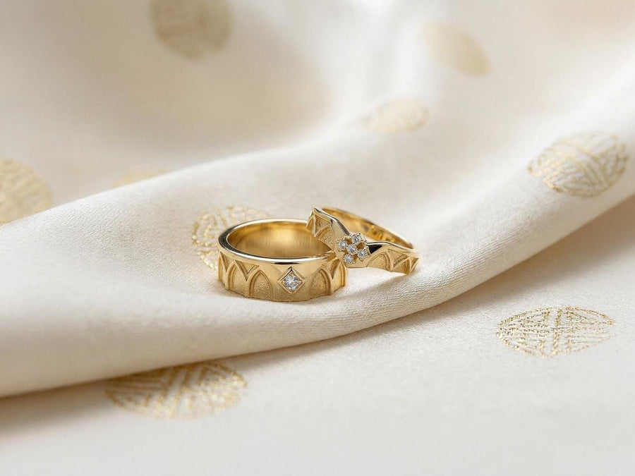A professional studio photograph of a matching two-piece sterling silver wedding ring set. Both rings feature a prominent, raised Greek-style cross motif in the center, which holds a round, bezel-set white crystal. The interior of the cross arms has a fine, cross-hatched grid texture. Along the sides of the high-polished silver bands are recessed, four-lobed quatrefoil shapes. The rings are presented against a pitch-black background, making the p __etsy:8051335185