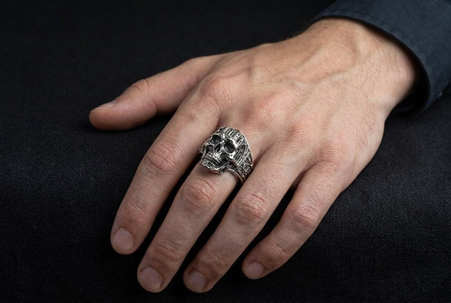 The exceptional micro-casting and silversmithing techniques used to construct this wearable sculpture are evident in its staggering detail. The relief work perfectly captures the delicate mullions of the stained glass windows alongside the anatomical jawline of the skull. The ring features a substantial thickness, with smooth inner bands polished flat to ensure a comfortable, everyday fit suitable for lifelong wear.