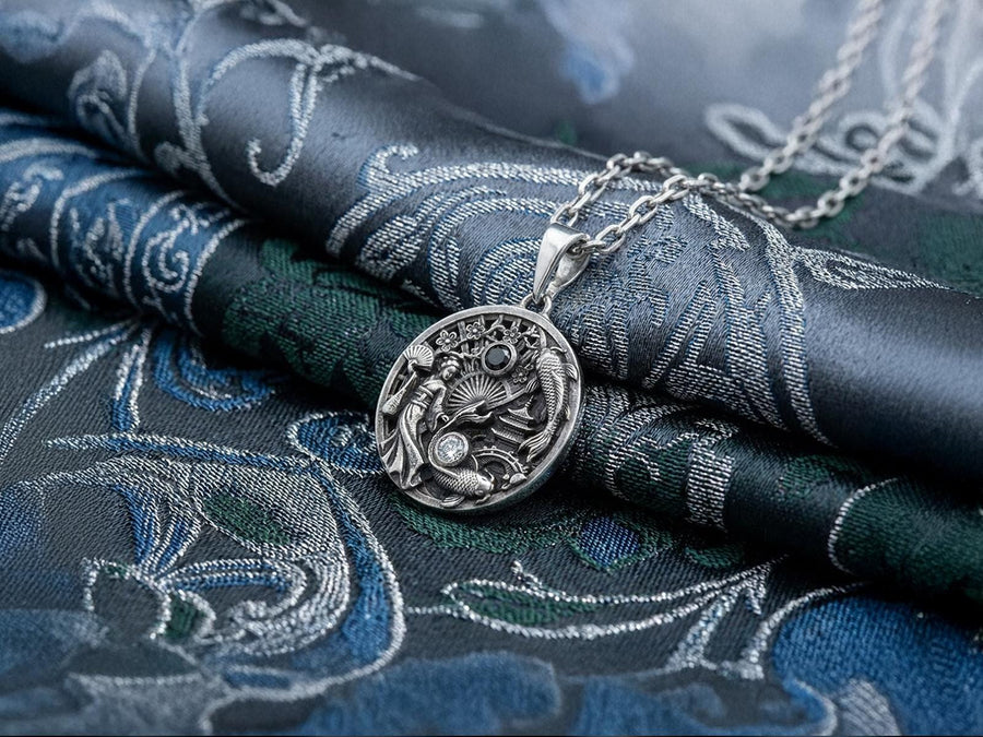 Crafted from solid 925 sterling silver, this intricate medallion demonstrates the visual impact of an antiqued patina. The heavy oxidation settles into the carved pagoda and the detailed scales of the koi fish. A dark black onyx and a sparkling clear gemstone add striking contrast to the silver.