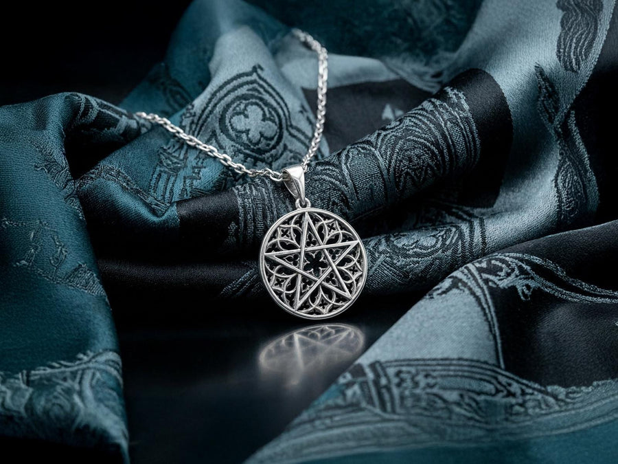A close-up studio photograph of image_61ba46.png, a circular 925 sterling silver pendant on a black background. The design features a bold, sharp pentagram overlapping an intricate background of openwork gothic cathedral tracery and carved quatrefoil motifs. This striking artisan pendant captures the mesmerizing geometry of medieval architecture. Bright studio lighting illuminates the highly polished lines of the silver five-pointed star, contras