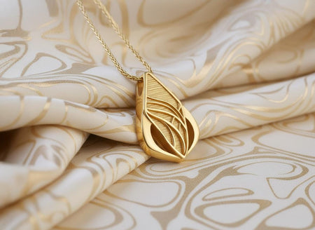 Biomechanical Leaf Amulet, Avant Garde Elven Jewelry, Gold plating Heavy oxidation settles into the crevices of the textured background, giving this abstract silver pendant a shadowed character. Reimagined in 18k solid yellow gold, this futuristic sci-fi pendant transforms into a radiant sunlit artifact. The warm tones illuminate the sweeping intersecting lines and textured teardrop shape. A subtle matte finish replaces the dark oxidation, gleami
