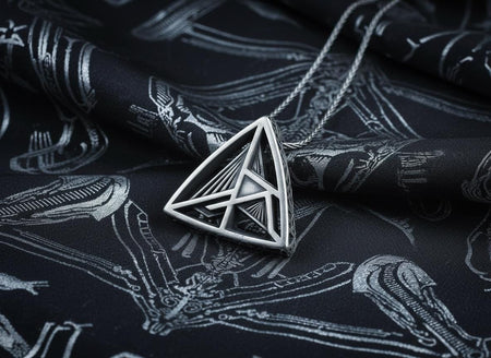 Embrace the structural elegance of modern ruins and sacred geometry. This architectural silver triangle pendant is a bold statement piece, designed for those who find beauty in precise lines and open space. Crafted from 925 sterling silver, the necklace features a complex, three-dimensional geometric framework that creates a captivating optical depth, making it a true centerpiece of alternative jewelry. The avant-garde triangular design features