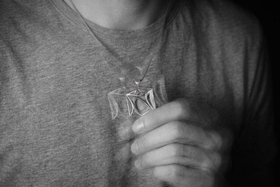Inspired by the concept of architectural portals and the chaotic grace of natural elements, this amulet feels like a relic of an advanced civilization. The design masterfully balances a structured outer frame with sweeping, wind-like internal curves, creating a dynamic visual rhythm. It is a modern dark artifact that grounds your spirit while elevating your everyday aesthetic.