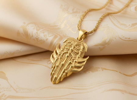 24K gold plated version of a biomechanical ribcage pendant glowing against dark mesh fabric and dramatic lighting.