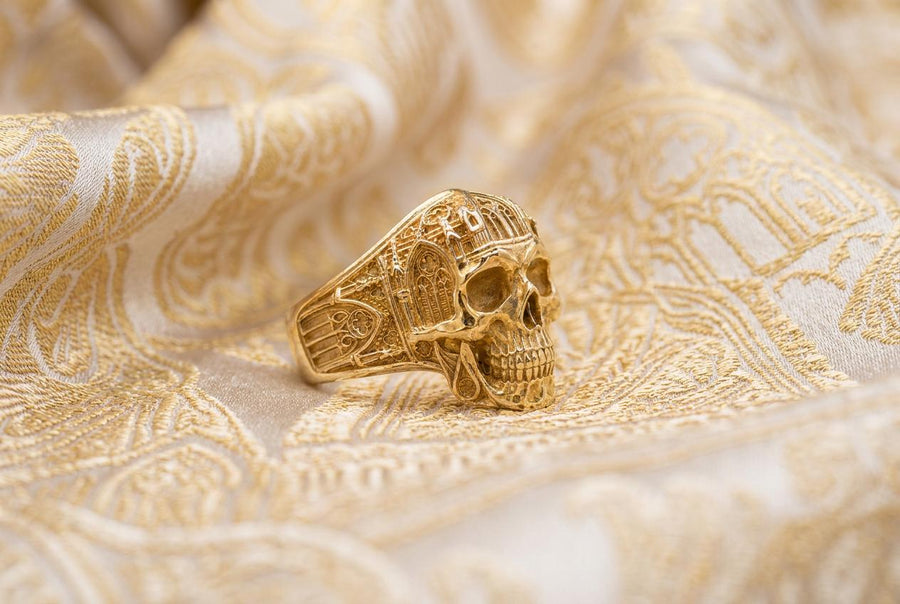 The exceptional micro-casting and silversmithing techniques used to construct this wearable sculpture are evident in its staggering detail. The relief work perfectly captures the delicate mullions of the stained glass windows alongside the anatomical jawline of the skull. The ring features a substantial thickness, with smooth inner bands polished flat to ensure a comfortable, everyday fit suitable for lifelong wear.