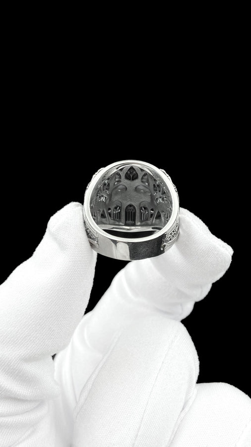 Crafted from premium solid 925 sterling silver, this substantial ring demonstrates the visual impact of an oxidized patina. The antiquing treatment settles into the microscopic crevices of the detailed gothic tracery and side cross engraving, providing a permanent shadow and an ancient, textured character.
