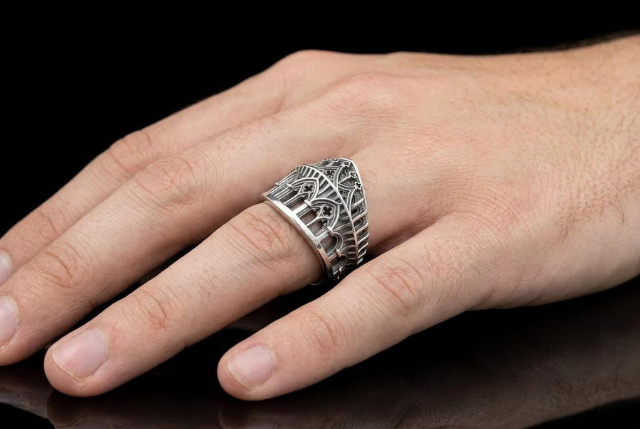 This striking artisan ring perfectly captures the monumental scale of medieval architecture. Bright studio lighting illuminates the polished silver arches and columns, contrasting beautifully with the deep, dark oxidation inside the hollow windows and recesses. Crafted from premium solid 925 sterling silver, this wide architectural band demonstrates the visual impact of an antiqued patina. Heavy sulfur oxidation settles into the intricate crevice