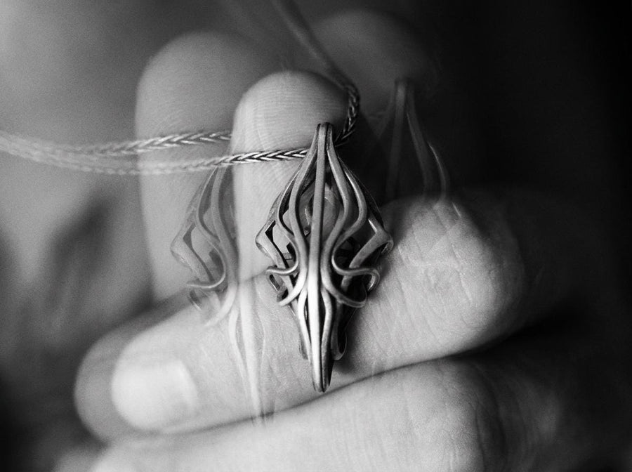 Choose between an Anchor or Foxtail chain to complete your look. Heavy oxidation settles into the textured inner curves, giving this openwork geometric pendant a shadowed, minimalist character.Exceptional silversmithing is evident in this oxidized silver avant-garde necklace. The relief work perfectly balances the sharp structural points with smooth, sweeping interlaced inner curves. A bold modern statement piece for alternative jewelry collector