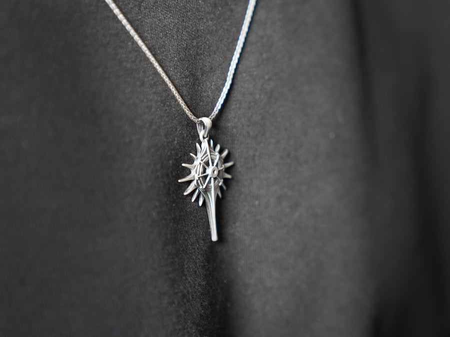 Man wearing a geometric dark fantasy starburst pendant on a silver chain against a black shirt. Celestial Star Silver Pendant for Men, Fantasy Compass Necklace, Gothic Sunburst Amulet, Sci-Fi Artifact, Oxidized Silver Navigator Jewelry