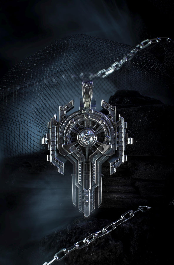 Front view of an oxidized silver sci-fi key necklace with a central blue stone isolated on white.