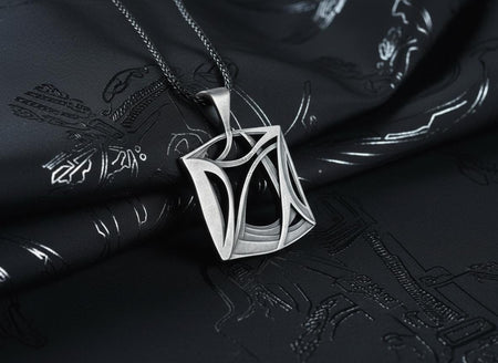 Discover the beauty of fluid motion captured in rigid form. This abstract square silver pendant is a striking piece of wearable modern art, designed for those who appreciate the tension between strict geometry and organic flow. Forged from solid sterling silver, this avant-garde necklace serves as a bold, sophisticated centerpiece for any dark alternative or futuristic wardrobe.