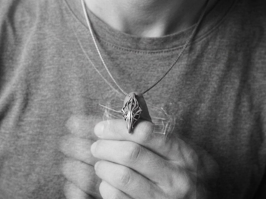Choose between an Anchor or Foxtail chain to complete your look. Heavy oxidation settles into the textured inner curves, giving this openwork geometric pendant a shadowed, minimalist character.Exceptional silversmithing is evident in this oxidized silver avant-garde necklace. The relief work perfectly balances the sharp structural points with smooth, sweeping interlaced inner curves. A bold modern statement piece for alternative jewelry collector