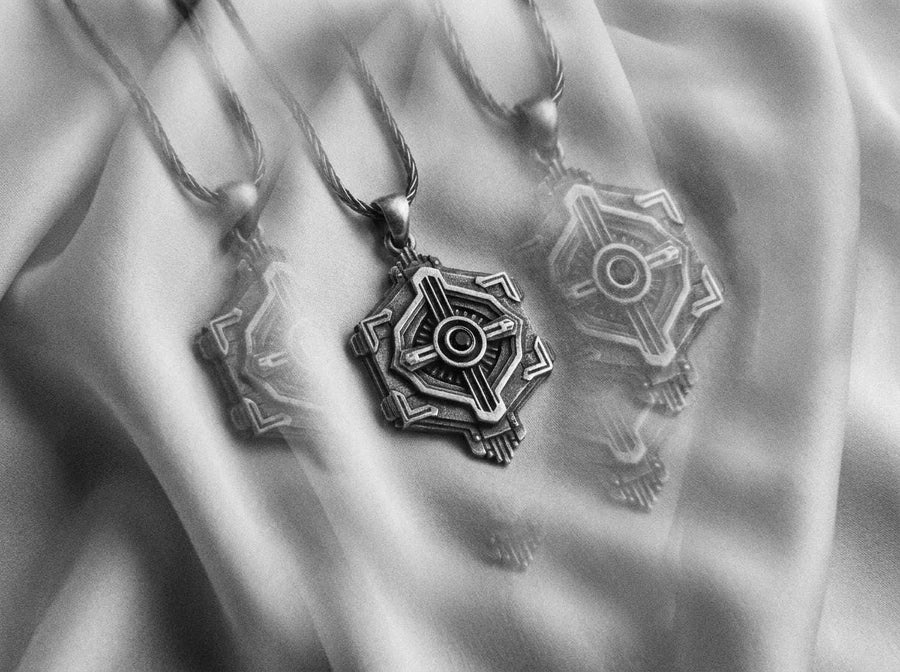 Cyberpunk silver hexagon pendant resting on a bare chest, showing a mechanical design centered around a blue stone.