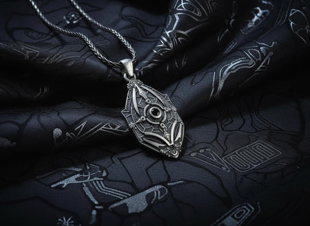 Unique artisan crafted silver armor necklace for men, fantasy sci-fi jewelry, A close-up studio photograph of a 925 sterling silver shield pendant resting on a dark reflective surface. The avant-garde design features geometric plating and a central circular core, highlighted by a dark matte oxidized finish. This striking artisan pendant captures the essence of futuristic armor.