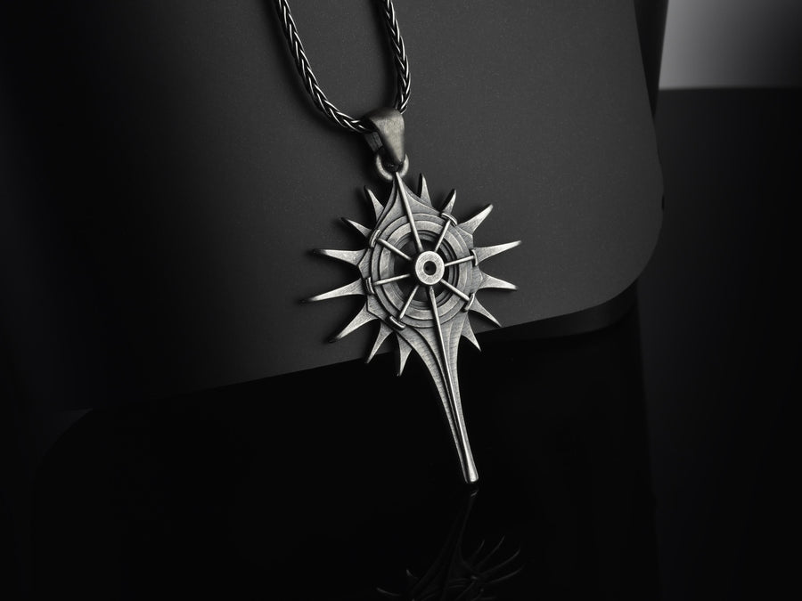 Man wearing a geometric dark fantasy starburst pendant on a silver chain against a black shirt. Celestial Star Silver Pendant for Men, Fantasy Compass Necklace, Gothic Sunburst Amulet, Sci-Fi Artifact, Oxidized Silver Navigator Jewelry