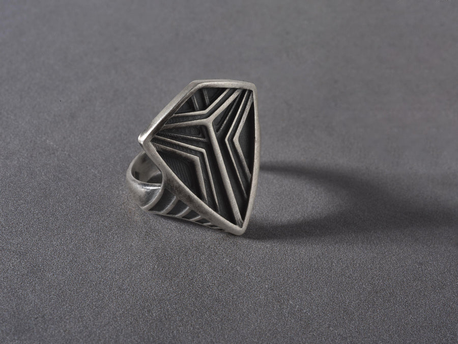 Channel the aesthetic of a high-tech future with this solid 925 sterling silver sci-fi shield ring. Designed with a sleek, low-profile silhouette, this minimalist signet features a sharp geometric crest anchored by deep, oxidized tri-line grooves.