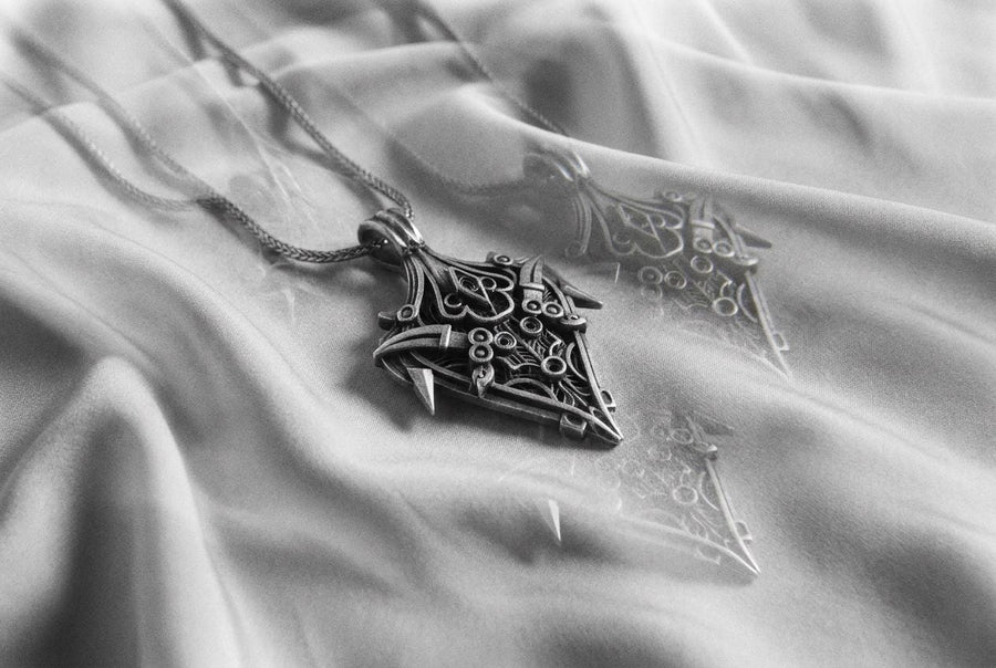 Dark fantasy shield design featuring sharp, armor-like blade accents and a spearhead silhouette.