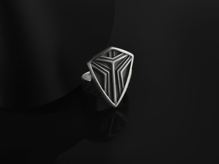 Channel the aesthetic of a high-tech future with this solid 925 sterling silver sci-fi shield ring. Designed with a sleek, low-profile silhouette, this minimalist signet features a sharp geometric crest anchored by deep, oxidized tri-line grooves.