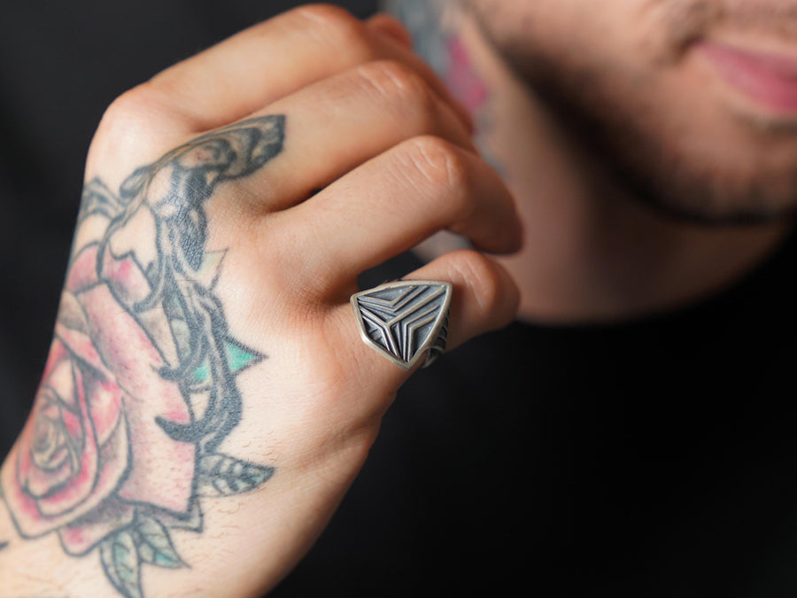 Channel the aesthetic of a high-tech future with this solid 925 sterling silver sci-fi shield ring. Designed with a sleek, low-profile silhouette, this minimalist signet features a sharp geometric crest anchored by deep, oxidized tri-line grooves.
